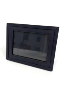 Louis Vuitton Henri Dark Navy Blue Picture Frame PM, front three-quarter view standing on its easel