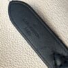 Heat stamp reading LOUIS VUITTON PARIS on the black leather tab
