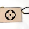 The matching pochette with its wrist strap