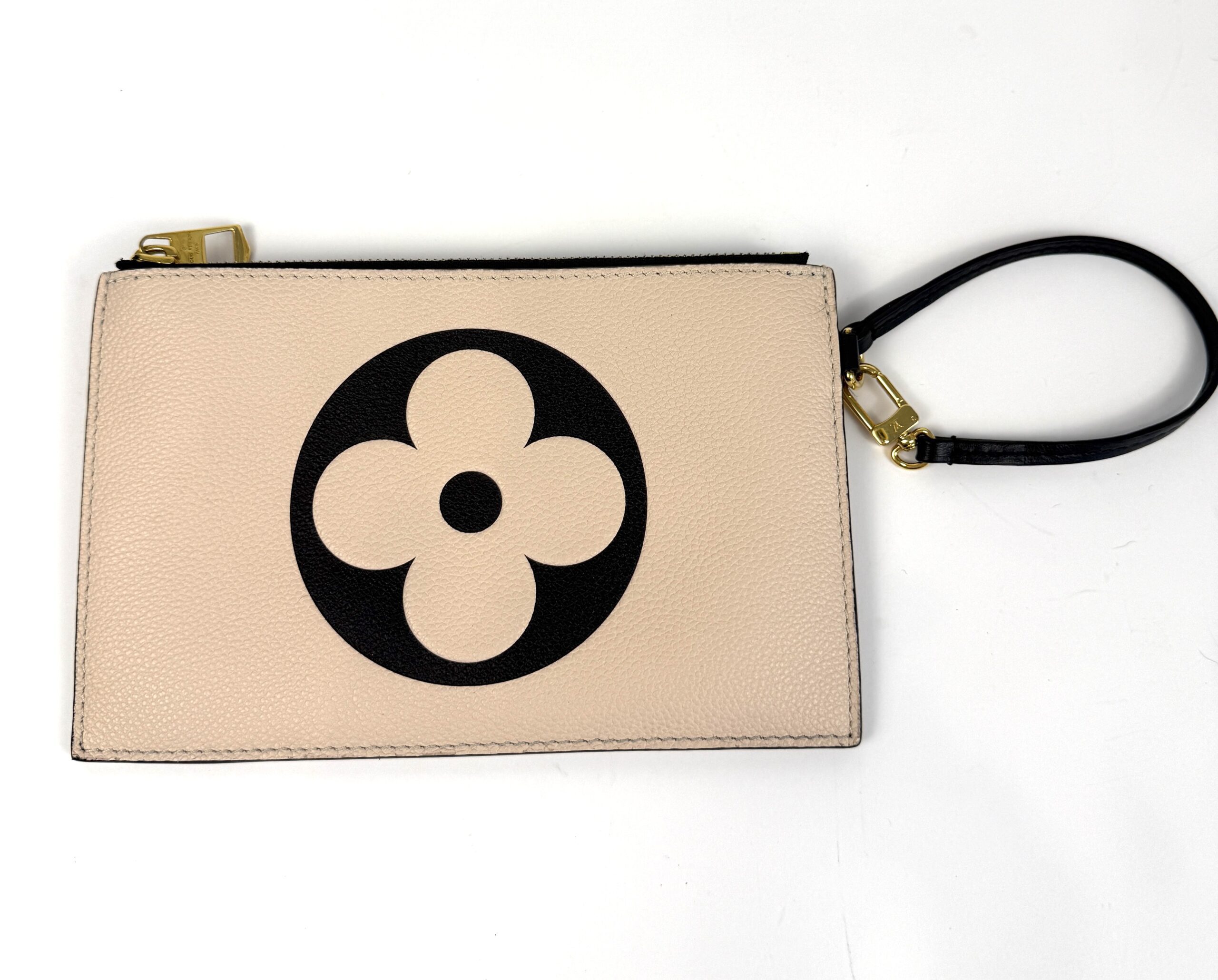 The matching pochette with its wrist strap