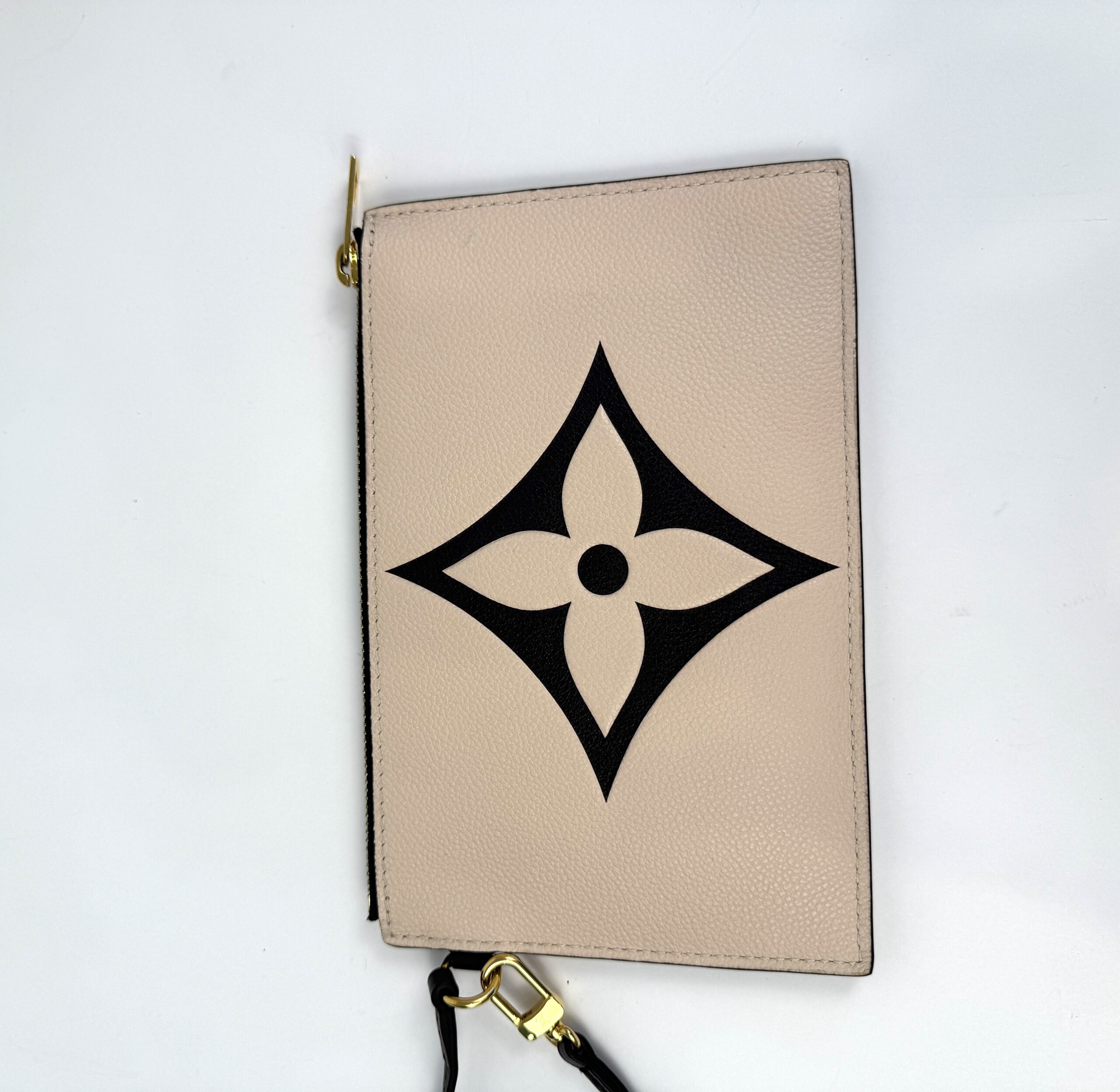 Pochette laid flat showing the embossed flower