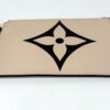 Pochette with its gold zip and wrist strap