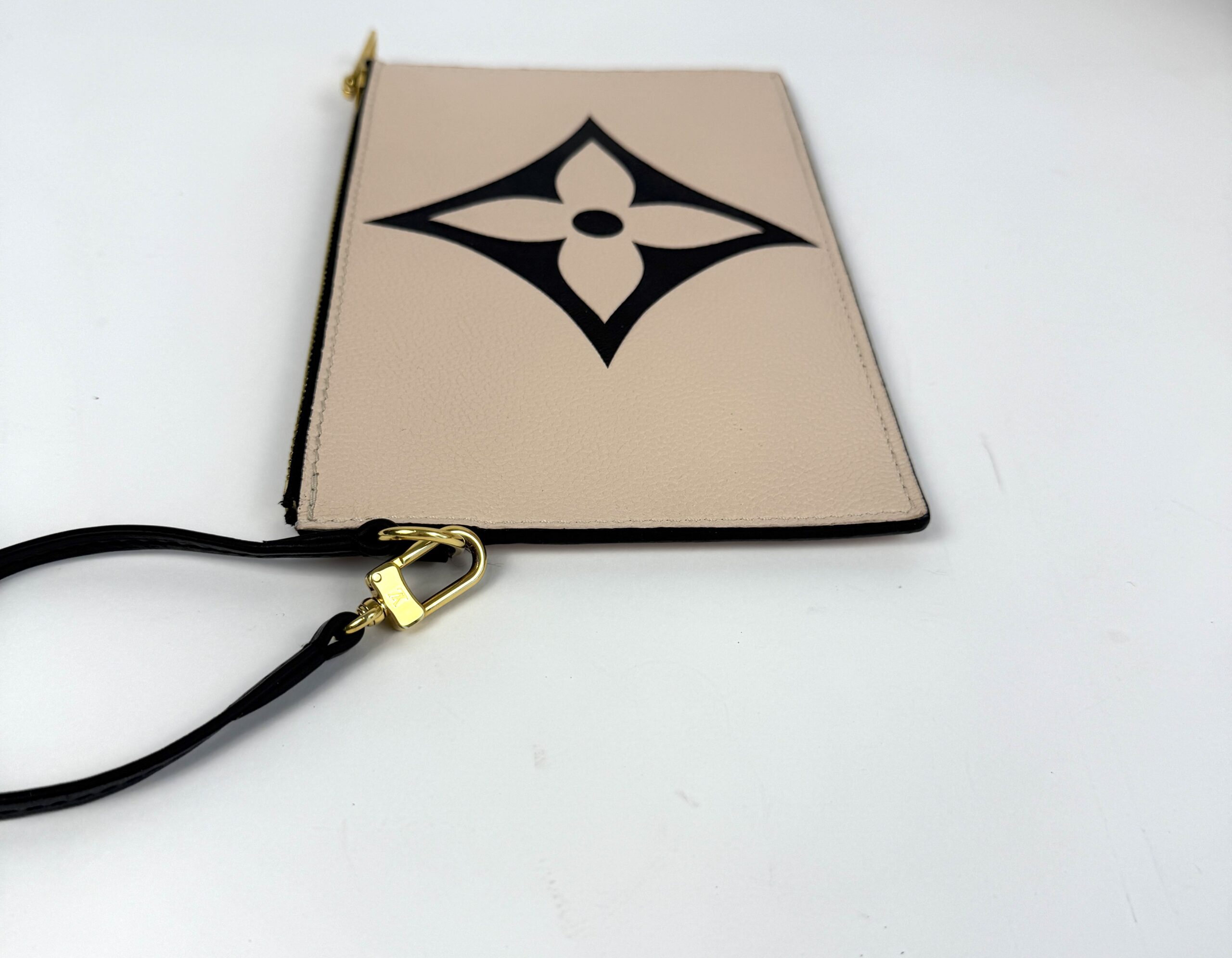 Pochette from an angle with its strap