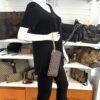 The pochette carried as a wristlet on a mannequin in the shop