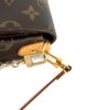 Side leather tab and clasp close up