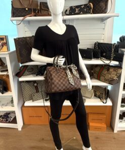 Styled on a mannequin, carried in hand with the twilly