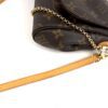 Strap clasp and chain at the side of the bag