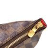 Gold zip pull close up at the end of the top zip